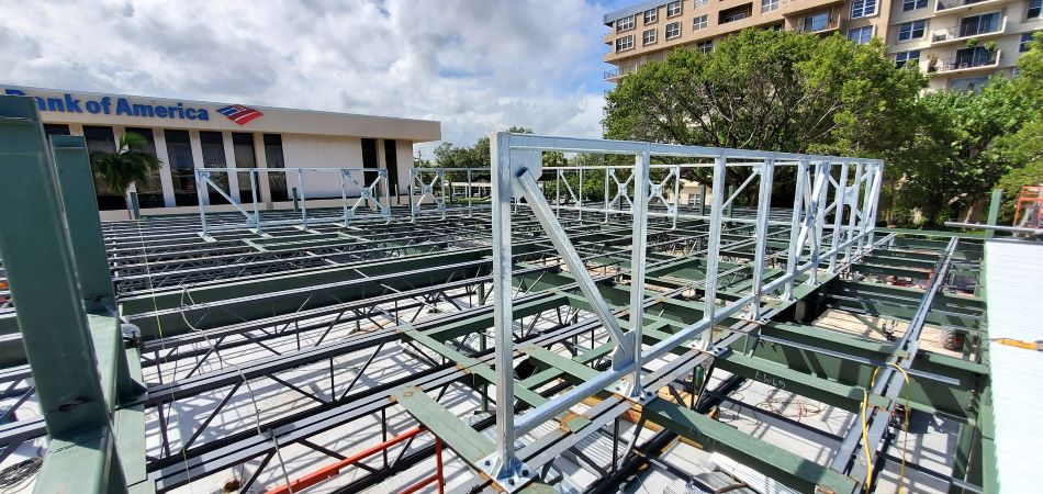 Galvanized steel purlins stacked on warehouse floor ready for bulk shipment